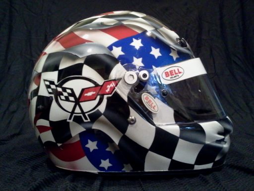 Racing helmet featuring checkered pattern and American flag design.