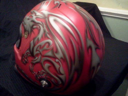 Red helmet with intricate silver dragon designs.
