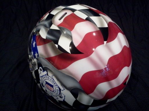 A motorcycle helmet featuring a design of red and white stripes with black and white checkers.